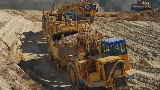 A convoy of giant machines moving mountains