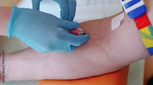 Nurse collecting blood from patient vein into syringe.The process of blood sampling from the vein for examination. Close-up.
