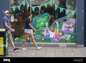 London, UK. 21 June  2025 US Player Madison Keys walks past the window of Bayley  &  Sage grocery store in Wimbledon village decorated for the tennis championships at the All England Lawn Tennis club   Credit Amer Ghazzal/Alamy Live News Stock Photo - Alamy