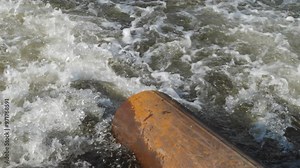 dirty waste water flows from a pipe into a river polluting and poisoning fresh water, industrial waste, industrial water is discharged into a reservoir, problems of ecology and fresh water