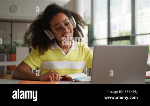 Friendly smiling talking African American woman university student girl talk video call greeting hello in laptop computer communicating online class lesson ethnic female smile study wearing headphones Stock Video Footage - Alamy