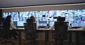 Security Guards Monitoring Modern CCTV Cameras in Surveillance Room