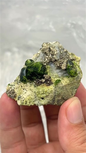 Mirson Fine Minerals on Instagram: "💚 Demantoid Garnet Combined with Pyrite & Calcite An exceptional and rare combination specimen featuring lustrous green Demantoid garnet crystals associated with sparkling pyrite and contrasting calcite. The metallic shine of pyrite and the soft tones of calcite beautifully enhance the vivid green garnets, creating a visually powerful and highly aesthetic piece. ✨ Rare mineral association 💎 High luster & sharp crystals 🌍 Collector-quality specimen #FineMine