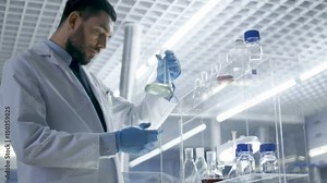 In a Modern Laboratory Research Scientist Picks up Beaker of the Shelf and Examines Content. Shot on RED EPIC-W 8K Helium Cinema Camera. Stock Video