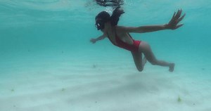 Woman snorkeling on shallow water. Beauty asian girl swimming in tropical sea