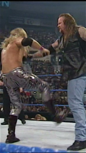 Undertaker catches Edge, levels him with a boot and delivers a devastating Chokeslam.