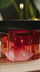 A rose-red crystal mousse cube sliced along a flawless horizontal line.