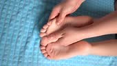 Children's therapeutic foot massage at home, body care concept