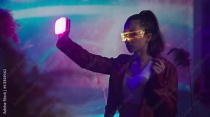 Futuristic young woman in VR environment with smart glasses. Concept of augmented reality game, futuristic lifestyle.