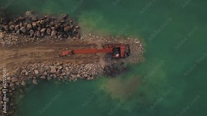 Construction of a new breakwater by Excavator machine, top down view
