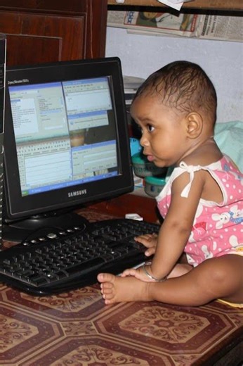 A baby is operating PC