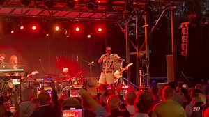 Travis Kelce performing in the Celebrity Karaoke Contest with Patrick Mahomes watching, and Rob Riggle and Kevin from "The Office" also on the mic. | Sports Radio 810 WHB