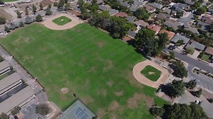 An aerial view of a baseball field with a green field