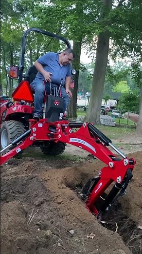 Massey Ferguson compact tractor backhoe digging