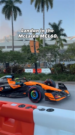 Lando Norris pushing the McLaren MCL60 through Miami during McLaren Racing Live: Miami 2026