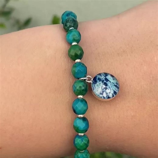 The Unite for Change Stretch Bracelet for Ovarian Cancer Awareness is a beautiful way to highlight your dedication to fighting for a cure. Wear your bracelet to celebrate your strength as a survivor while spreading hope for an ovarian cancer free future. This ovarian cancer bracelet features faceted Azurite and small sterling silver or gold beads with a round pendant that contains an Ovarian Cancer cell image under resin. Stack up your favorite causes and show your support in style! For every Un