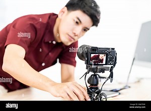 Young asian male blogger setting up camera for recording live vlog video tutorial session at home. IT blogging or vlogging, social media hobby broadca Stock Photo - Alamy