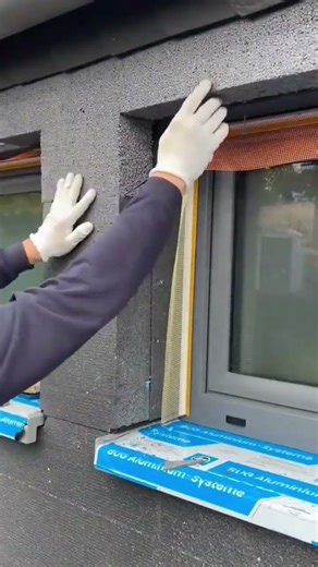 the process of installing black styrofoam blocks on the outer walls of the building #construction