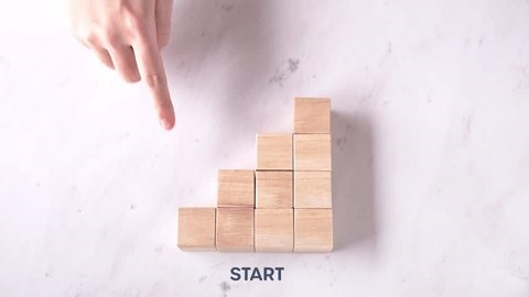 clip-3937289383-start-2026-concept-hand-pointing-wooden-blocks