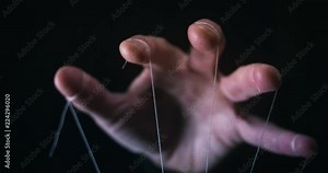 Manipulation concept with puppet string and controlling hand Stock Video