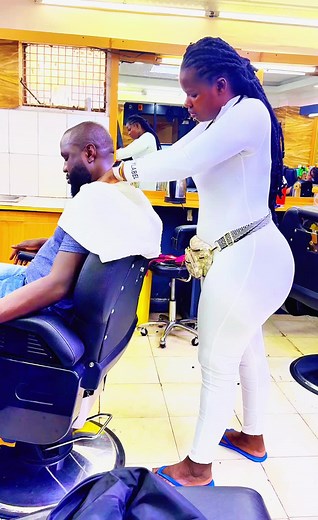 Female Barber Providing Therapeutic Services at Barbershop