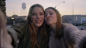 Teen Girls Hold Side Of Camera As If It's A Smartphone, They Pose And Make Silly Faces For Selfies