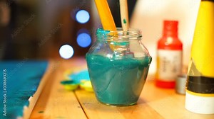 Colorimetry. Most pigments work by absorbing certain wavelengths of light. Other wavelengths are reflected or scattered, to see colours. The artist cleans brushes from blue paint in water.