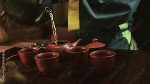 Traditional chinese tea ceremony on the tea table, close up, slow motion, dolly shot