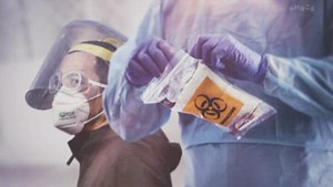 An undated scanning electron microscope image shows SARS-CoV-2 (yellow), the virus that causes COVID-19, isolated from a patient in the US.