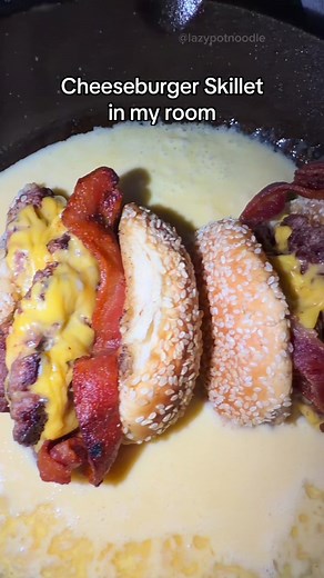 Making a cheeseburger skillet in my room! 🍔🧀 — This trend was super fun and delicious! Just make sure not to burn yourself on the skillet lol. Lazy Pots are also on Amazon! 😊 Instructions: * Ground beef * Bacon * Seeded burger buns * Ketchup & mayo * Salt & pepper * American cheese * Cheddar & Monterey Jack cheese * Butter * Flour * Milk Ingredients: 1. Cook bacon in a pot until crispy, then remove and set aside. 2. Roll ground beef into balls, smash into burger patties, season with salt and 
