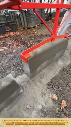 Skilled Worker Lifting Concrete Curb Blocks with Manual Clamp Tool for Safe and Controlled Placement