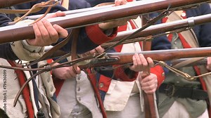 Soldiers line up during a revolutionary war battle reenactment