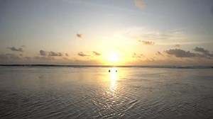 clip-3648508825-some-visitors-enjoying-beach-atmosphere-calm-sea
