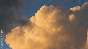 Time lapse of rolling puffy sunset clouds are moving, orange clouds time lapse. Clouds running across the cloudy sky. 4k Timelapse of white clouds with sunset sky background