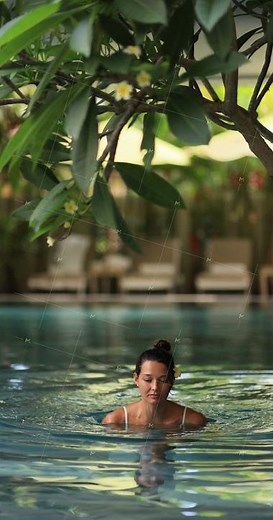 Beautiful Woman Swimming In Tropical Pool Relaxing At Luxury Resort
