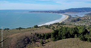 Aerial: beach and Seaside town of Stinson Beach, Marin near San Francisco, California, USA.