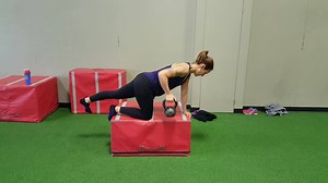Leanne demonstrates a very challenging rotational stability exercise - the bird dog row. While it looks similar to an ordinary bent-over row using a bench, the lifting of the opposite back leg (and the removal of a crucial point of balance) takes this exercise to a whole new level of difficulty. Leanne must maintain great control and resist the pull of the kettlebell trying to rotate her trunk and pull her off the box. On top of that, she has to have some solid rowing mechanics as well! Mastery 