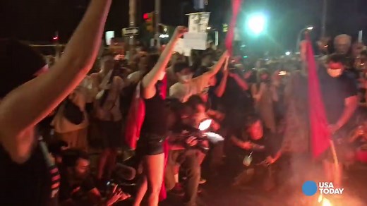 WATCH: Protestor catches fire while stomping on burning flag