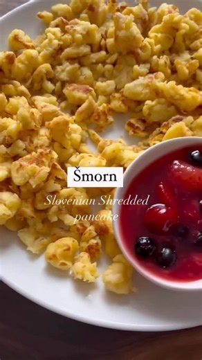𝗠𝗶𝗰𝗵𝗲𝗹𝗹𝗲 𝗣𝘂𝘀𝗶𝗰 𝗥𝘆𝗮𝗹𝗹 on Instagram: "ŠMORN 🤍 Fluffy, golden, and gently torn by hand — šmorn is a rustic Slovenian dish made from simple ingredients. Enjoyed for breakfast or even as a comforting meal, this shredded pancake is humble food the old way. We like to dust it with sugar and serve it warm with a side of homemade berry compote 🍓 Simple, nostalgic, and deeply satisfying. If you grew up with šmorn, this will bring you right back. If you’ve never tried it — now is the pe
