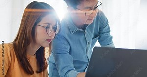 Asian male, female programming developer work together at home office, brainstorm discussion. Information technology, software engineer programmer coding job, man and woman coworker teamwork concept