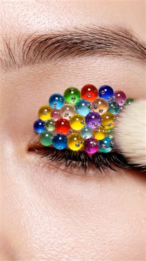 Tiny colorful glass marbles forming a hyper-real 3D eyelid design #marbles #eyelidart #fx