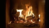 Burning fireplace with wooden logs and flame inside. Warm light,...