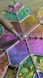 Finishing up my last dichroic snowflake for a while! Dichroic glass is so expensive, but oh so beautiful, and I can't stop using it! I have some sheets on order to restock my collection - the rainbow Florentine is one I cannot live without. #stainedglass #artptocess #wip #soldering #snowflakes #artist #art | Samantha Ashley Glass