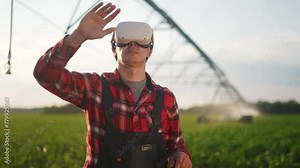 agriculture virtual reality. a farmer in virtual reality glasses controls a machine to irrigate corn field. agriculture virtual reality concept. a farmer vr business in works in field with corn Stock Video