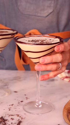 This decadent Chocolate Martini is a boozy dessert in a cup that’s perfect for your end of the year festivities. Vodka, Baileys, and chocolate liqueur shaken over ice and garnished with chopped chocolate is easy as can be and so good! Recipe up on the blog #preppykitchen #baker #recipevideo | Preppy Kitchen