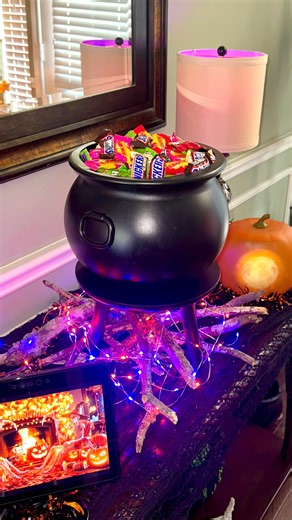 Kaitlyn Anderson on Instagram: "DIY CAULDRON CANDY BOWL 🍭🍬🍫 This is such a fun way to display your Halloween candy and beats a basic bowl all day! IN BIO: 🔗Supplies linked on my LTK & Amazon 👩🏼‍🍳‘Cozy Comfort Meals’ recipe ebook 🗞️’Savor n’ Season’ weekly newsletter SUPPLIES: -Sticks -String lights -Cauldron -Plant table -Candy DIRECTIONS: 1. Arrange sticks and add string lights. 2. Set plant table overtop. 3. Add cauldron and fill with candy. 4. Enjoy this fun display on Halloween night
