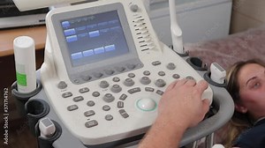 Doctor setting up an ultrasound machine at a medical center.