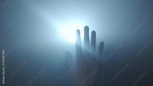 Silhouette in lighting concept. Female model against bright backlight on black smoky background in studio. Female silhouette with a moving hand playing with a beam of light in the dark. Close up.