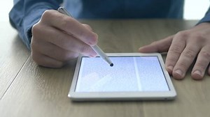 clip-17691739-man-reading-ebook-on-digital-touch-screen