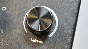 Man turning a volume knob all the way up, making music sound audio louder, setting loudness to the max level, excessive noise complaints simple abstract concept, one person. Music too loud symbol